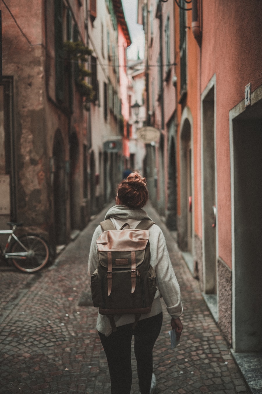 Traveller with a backpack strolling an old-town alley