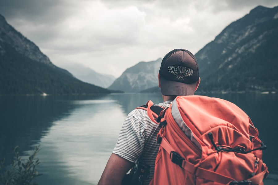 Traveller with a backpack at a mountain lake