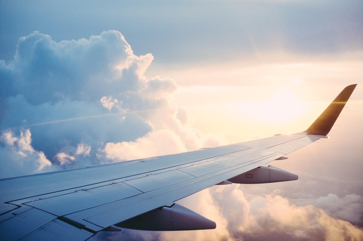 View over the wing of a plane at sunset